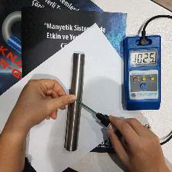 Measuring a magnetic rod's field strength with a digital Gaussmeter.
