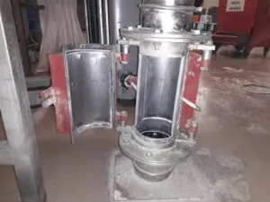 Stainless steel magnetic plate separator with an open hinged door for pipeline inspection and cleaning.