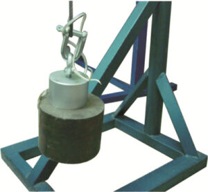 Cylindrical electro magnet lifting a heavy metal weight in a controlled setting.